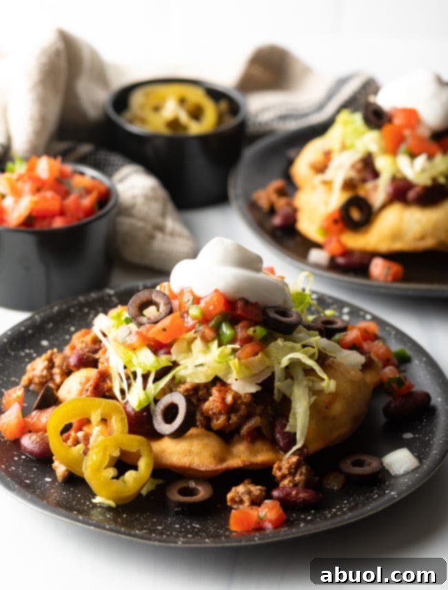 Indian tacos served on a black dish, beautifully garnished and ready to eat.