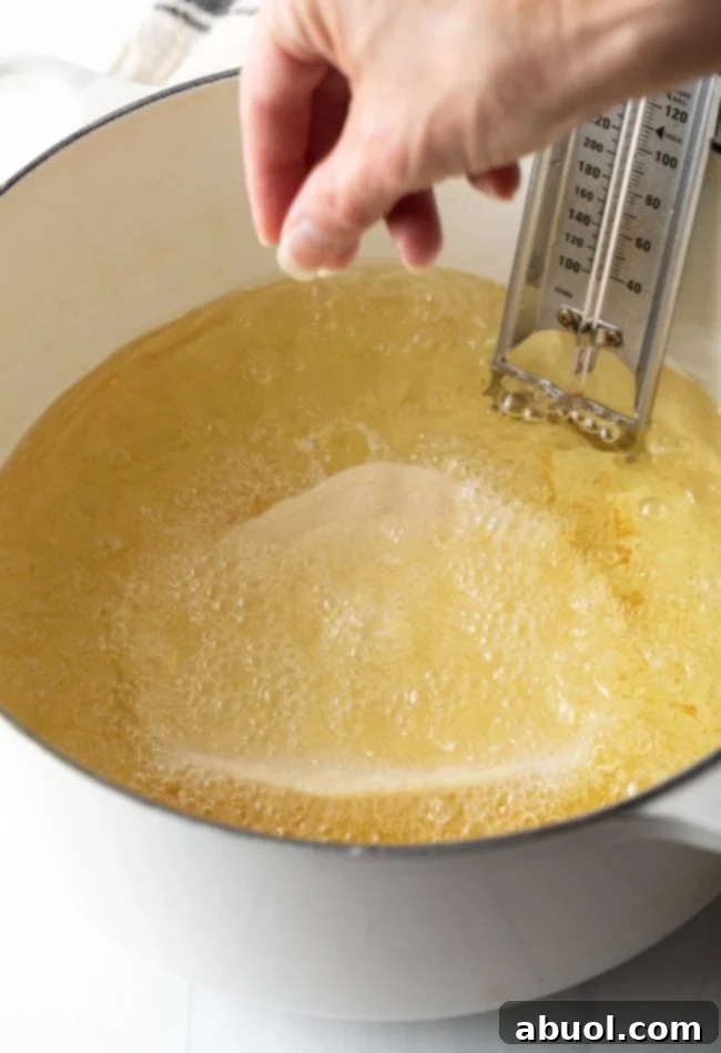 A single piece of Navajo fry bread frying in a large Dutch oven, bubbling and turning golden brown.