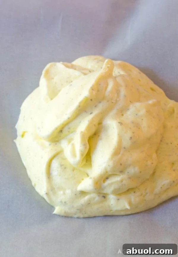 Cloud bread dough evenly spread on a baking sheet, ready for its first bake.
