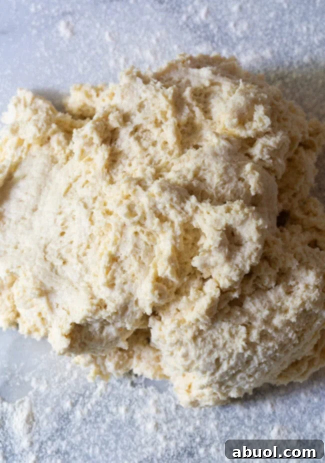 Fluffy Southern Cat Head Biscuits dough neatly arranged on a floured board, ready for cutting into impressive, oversized biscuits.