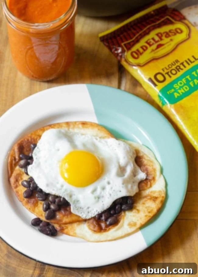 Stack of warm, lightly fried tortillas on a plate, ready for the toppings.