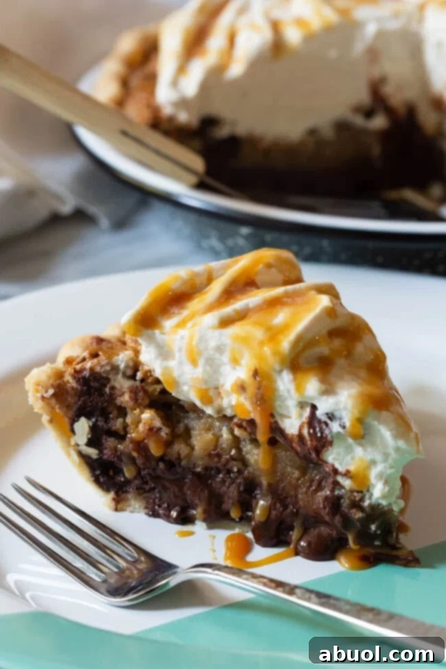 A decadent slice of Kentucky Derby Pie on a white plate with a fork, showing the gooey chocolate and pecan layers.