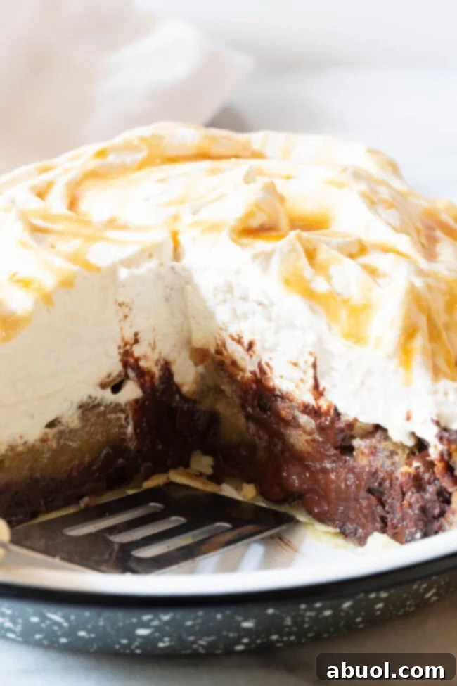 An inviting close-up of a slice of chocolate pecan pie, showcasing its gooey chocolate layer and crunchy pecans.