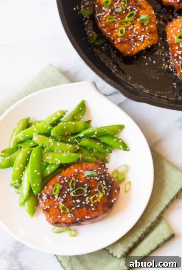 Spicy Korean Pork Chops in skillet and on plate served with sugar snap peas