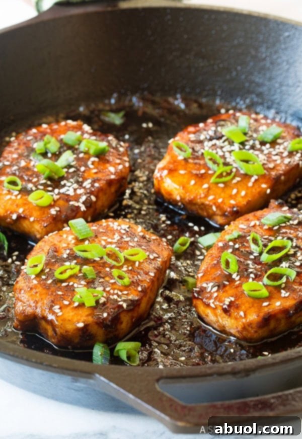 Korean Pork Chops Recipe in skillet with sesame seeds and green onions