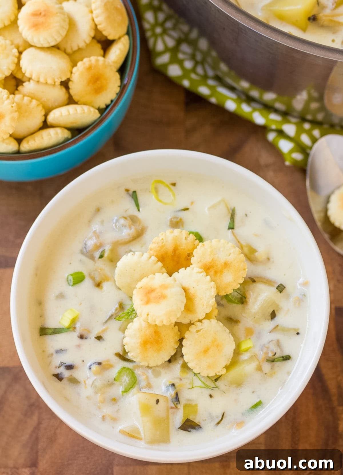 clam chowder recipe in a white cup with oyster crackers