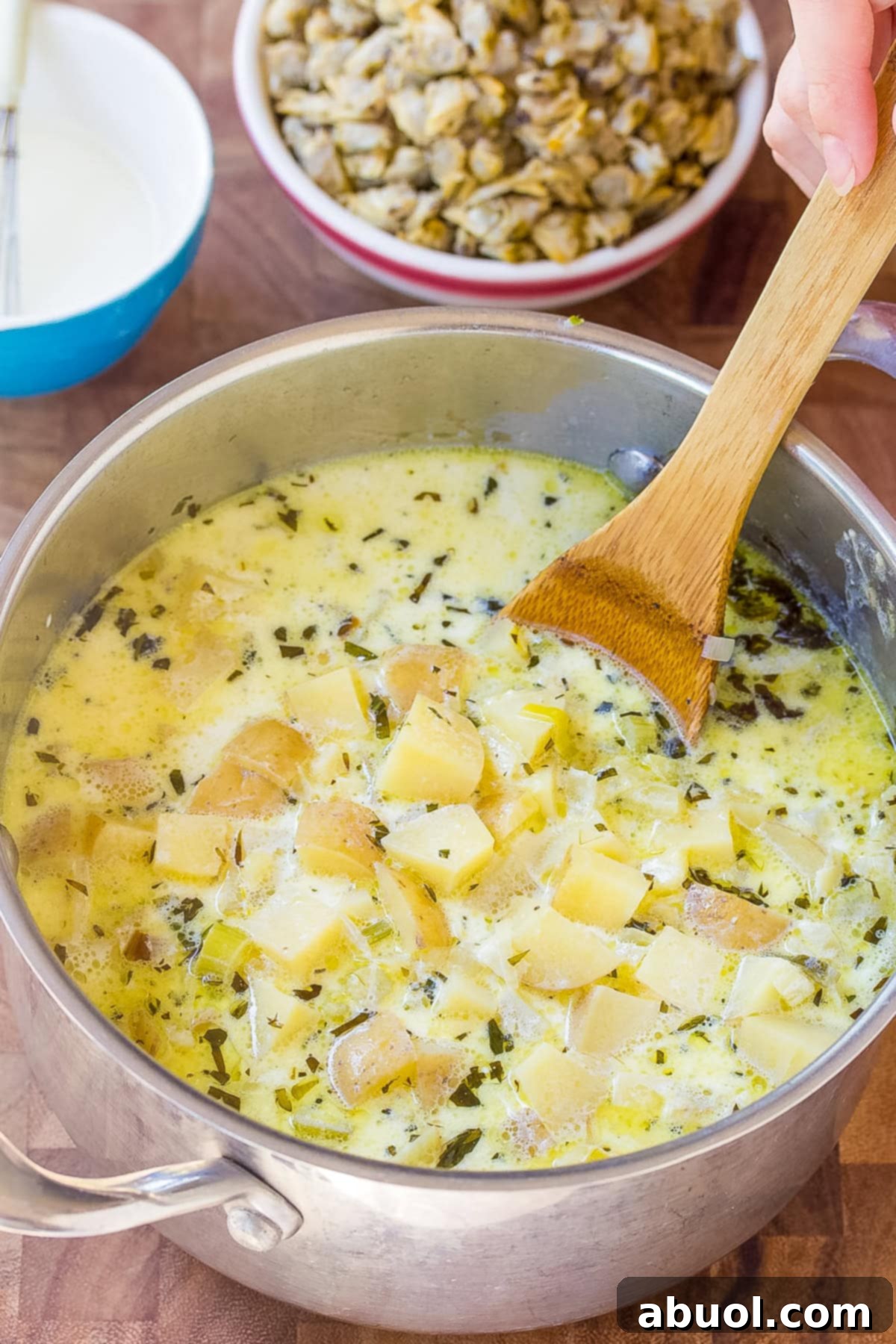 clams in soup with potatoes and herbs