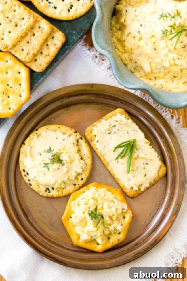 Top down view of plate with crackers topped with homemade cheese spread. 