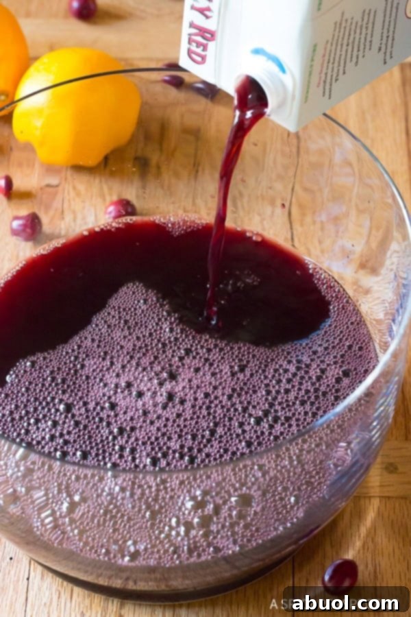 Wine Cocktails - Red boxed wine being poured into a glass punch bowl.