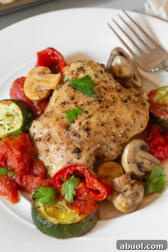 Plated Low Carb Sheet Pan Chicken Cacciatore served on a white plate with fresh herbs