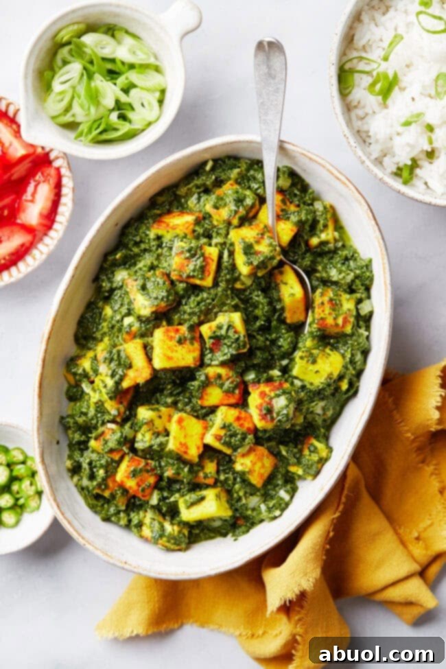 Overhead shot of plated saag paneer in a big white platter, garnished.