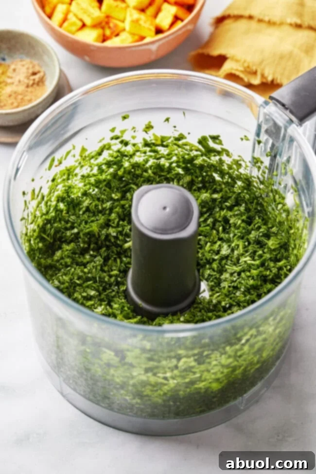 Finely chopped spinach in a food processor bowl.