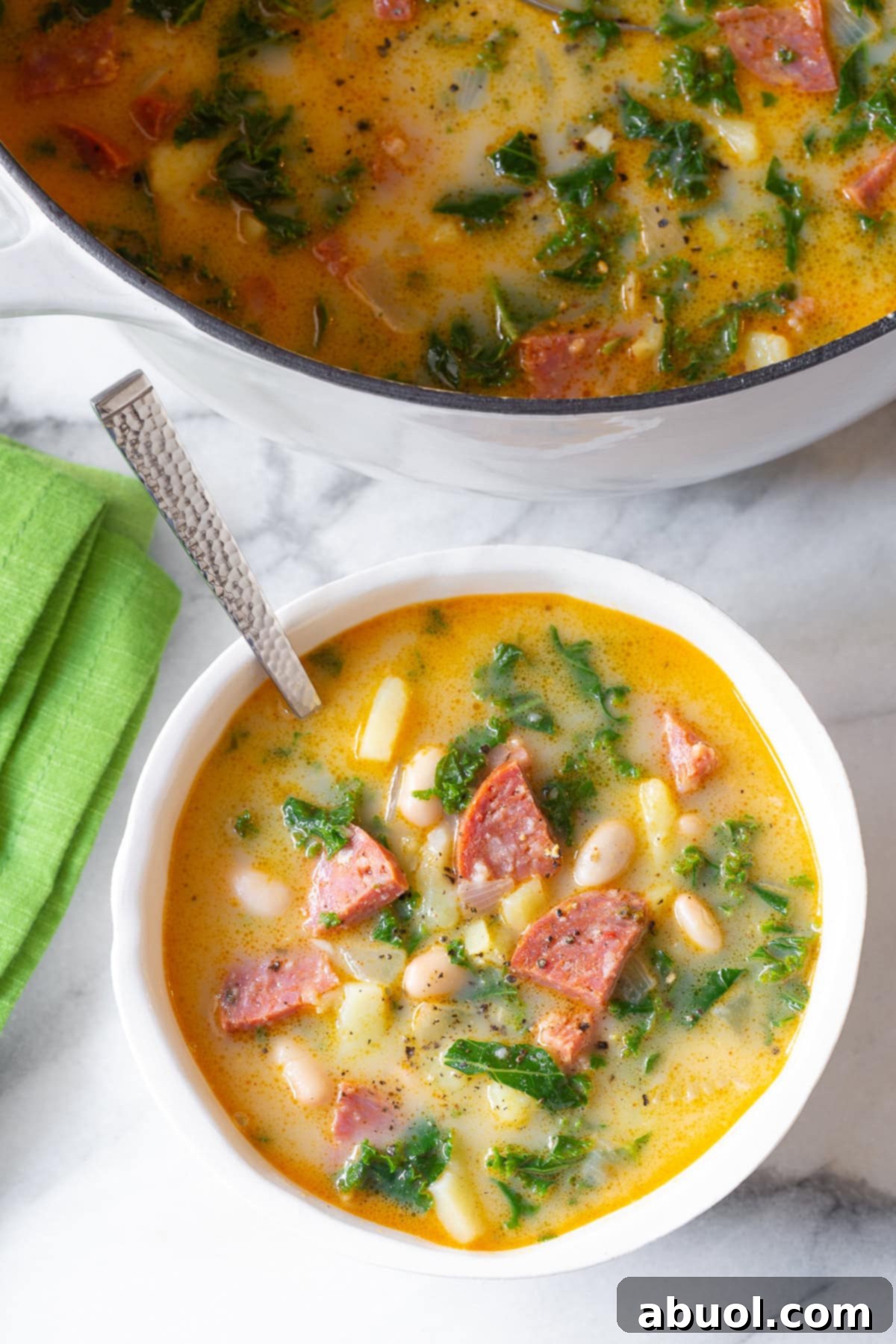 Portuguese kale soup - Caldo Verde Recipe in pot and bowl overhead view