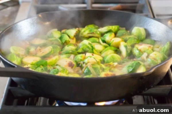 Braised sprouts in a cast iron skillet.