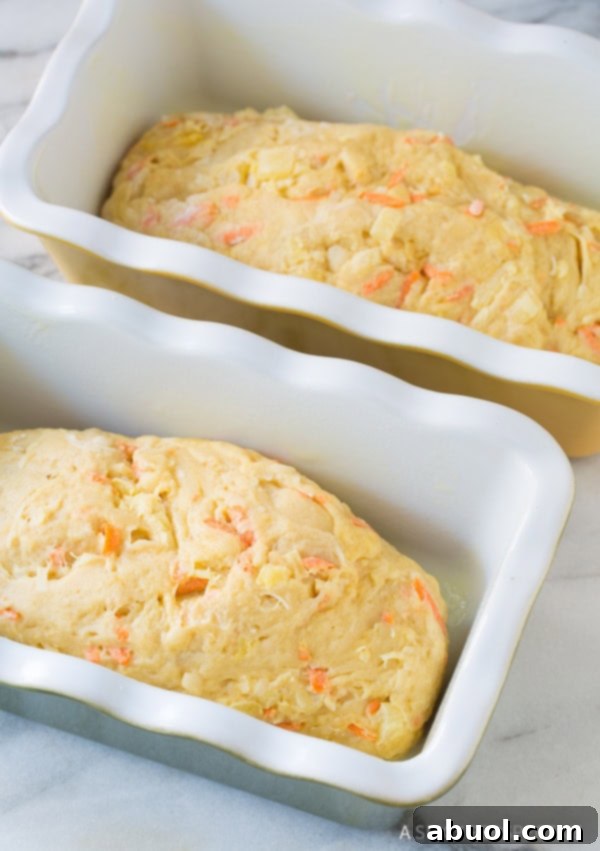 Pillowy Hawaiian Sweet Bread 7 Hawaiian bread dough beautifully rising in two loaf pans, ready for baking.
