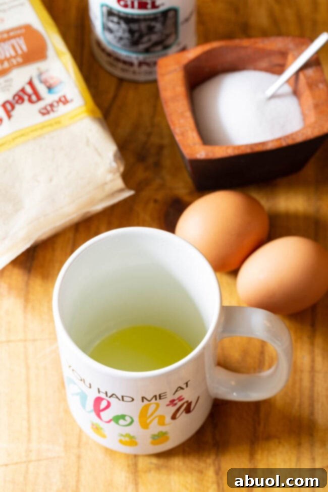 A pristine white mug, perfectly oiled and ready for the low-carb bread batter, sits on a clean surface.