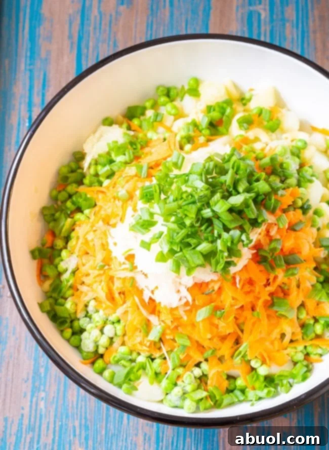 Ingredients for Hawaiian style macaroni salad in a large mixing bowl before being mixed.