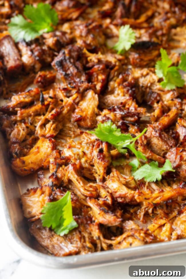 Crispy Instant Pot Carnitas 3 Shredded Instant Pot Carnitas spread on a baking sheet, ready for broiling to achieve crispy perfection