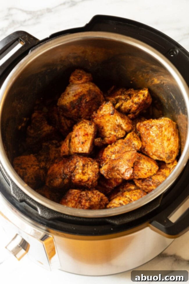 Crispy Instant Pot Carnitas 7 Chunks of seasoned pork butt roast browning in the pressure cooker for Instant Pot Carnitas