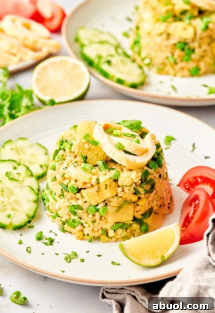 Up close shot of thai fried rice topped with green onions.