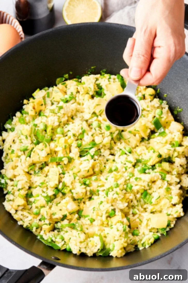 All of the ingredients for Thai fried rice in a large skillet together.