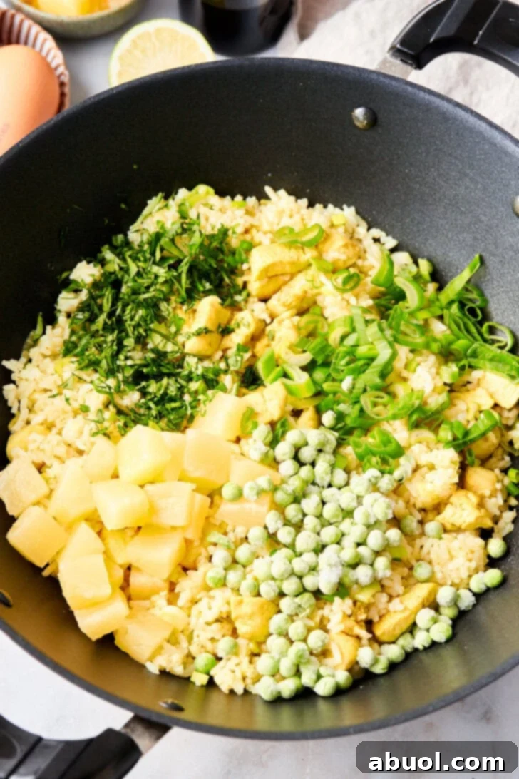 Vegetables for Thai fried rice in a large skillet together.