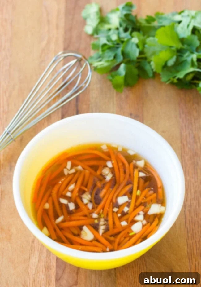 Nuc Cham Sauce in a small bowl with a whisk next to it. 