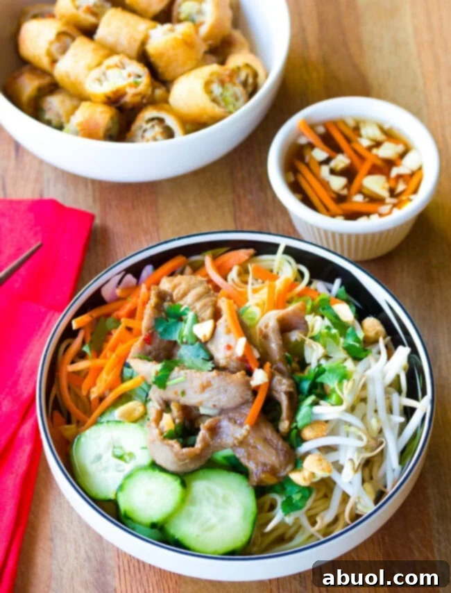 Vietnamese bun cha gio in a bowl with a small bowl of sauce on the side. 