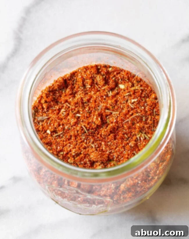 Another perspective of homemade blackened seasoning in a glass jar, ready for storage or use.