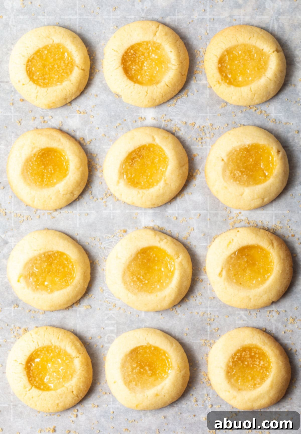 Top view of perfectly arranged lemon drop cookies on a baking sheet, ready to be enjoyed.
