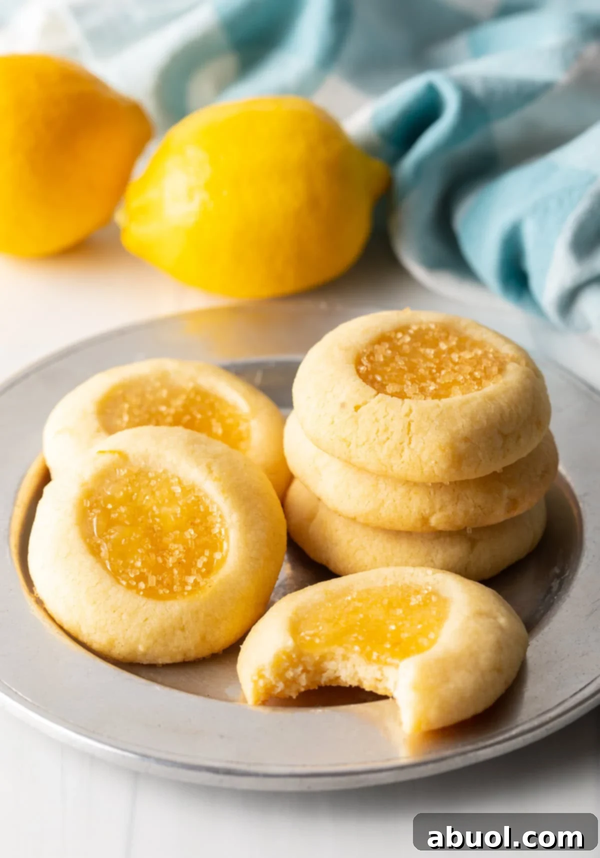 A handful of perfectly baked lemon cookies elegantly laid out on a decorative charger.