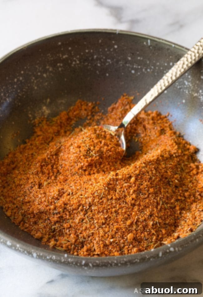 Steak seasoning in a small bowl with a little spoon, highlighting the texture and color of the rub. 