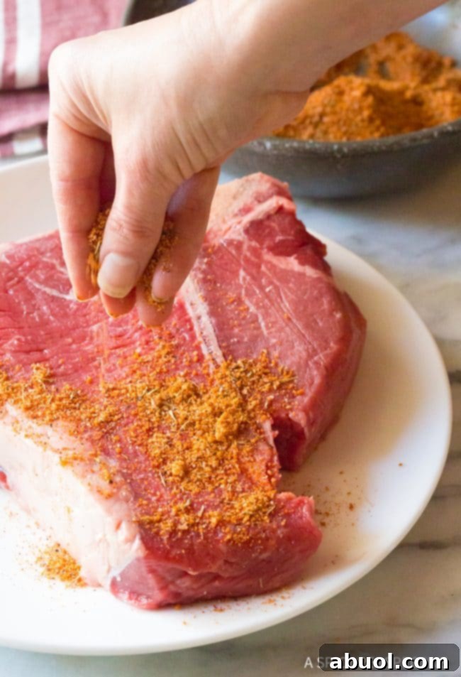 Making The Best Homemade Steak Seasoning Recipe (Simple Steak Rub!) - A raw steak thoroughly coated with the seasoning.