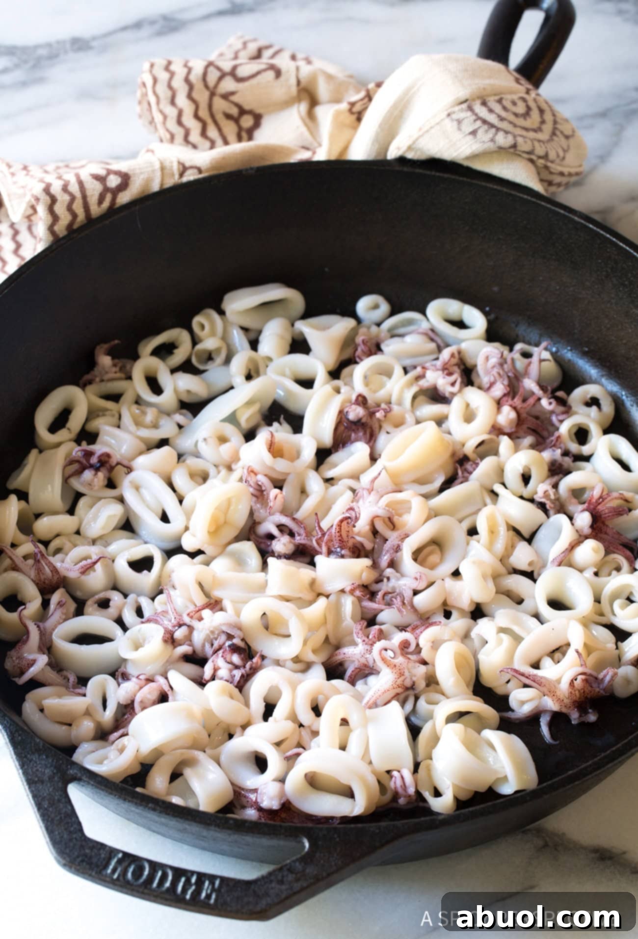 Octopus and squid in a cast iron skillet.