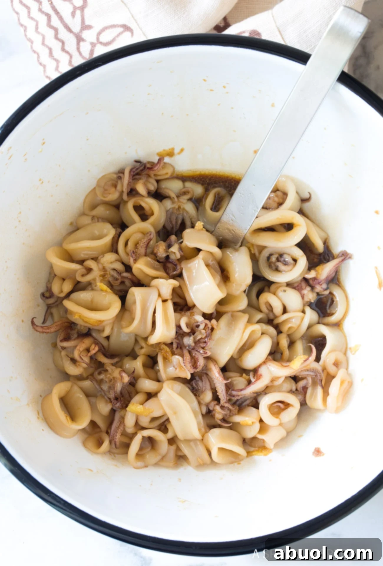 Making Hawaiian Poke Recipe - marinating squid in bowl