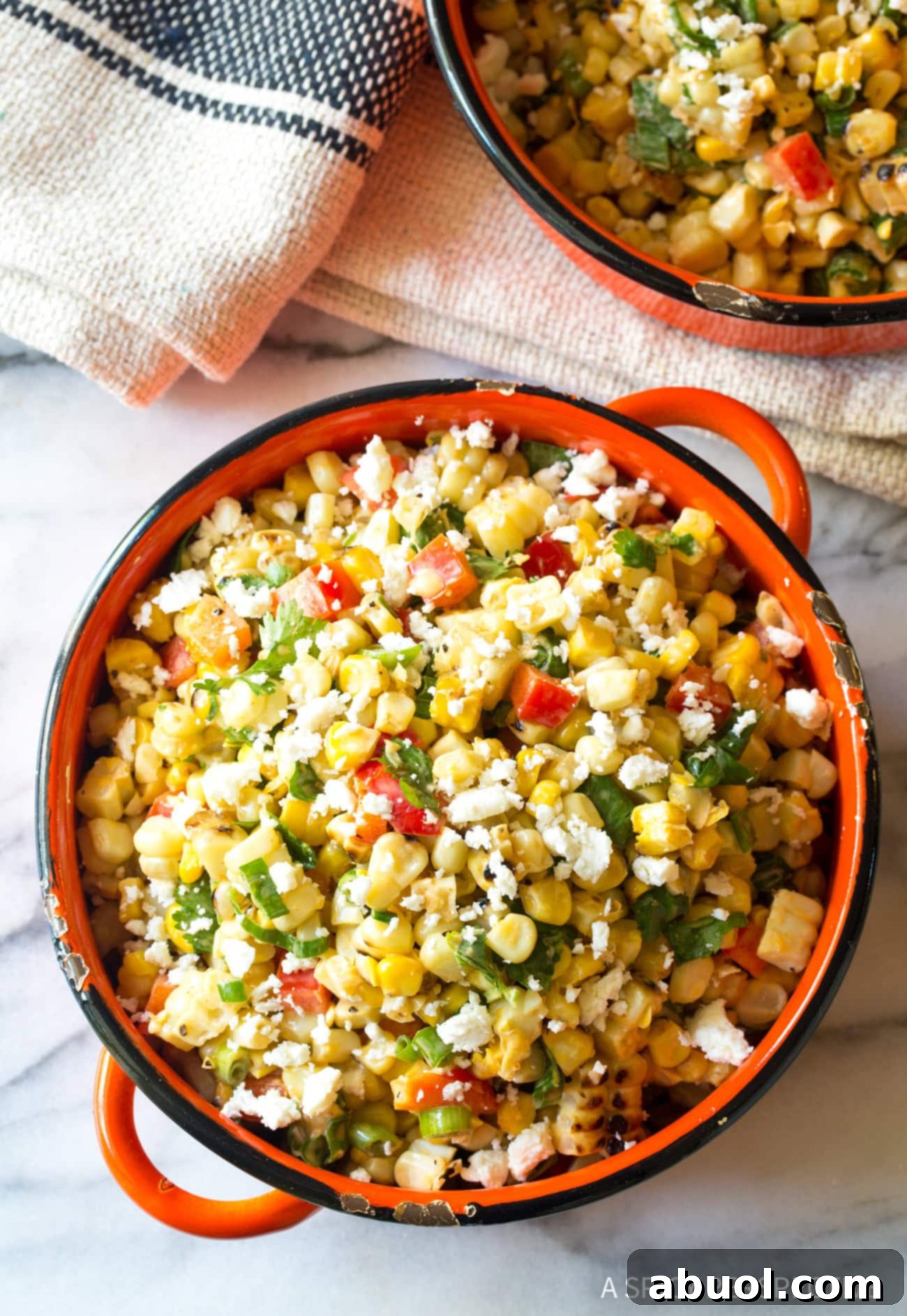 Overhead view of grilled Mexican street corn salad in a bowl. 