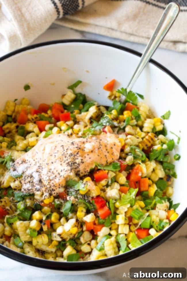 Creamy salad dressing being tossed into salad. 