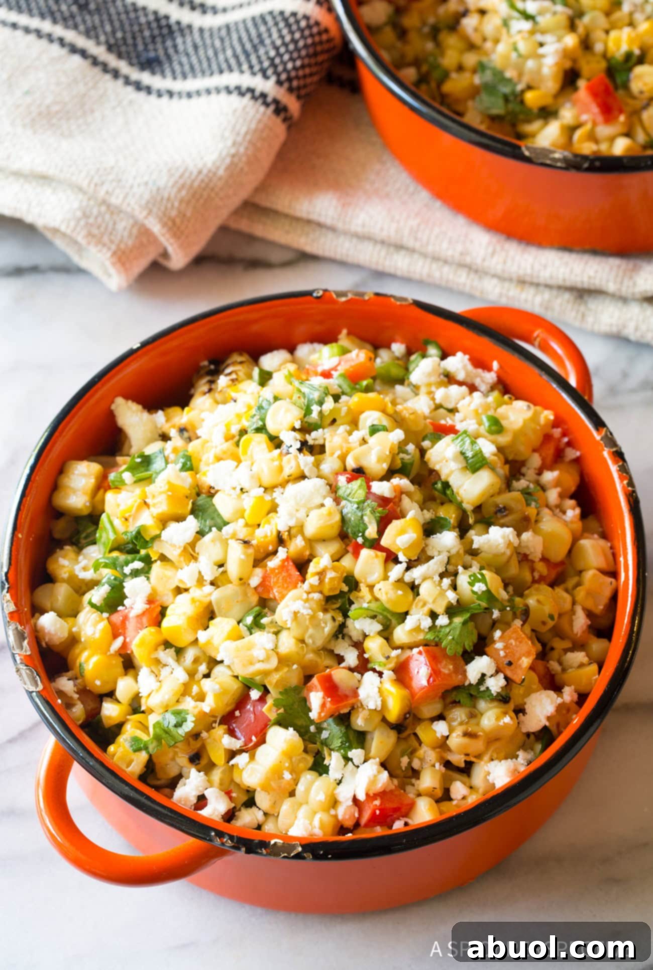 Closeup of Mexican Street Corn Salad served in an orange bowl. 
