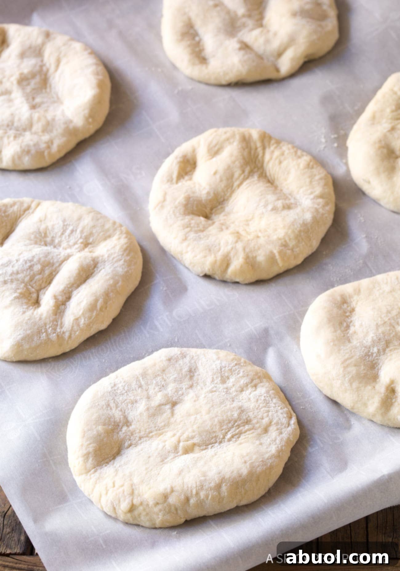 Fluffy Croatian Lepinja Bread 6 Lepinja Bread - disks of dough on baking sheet.