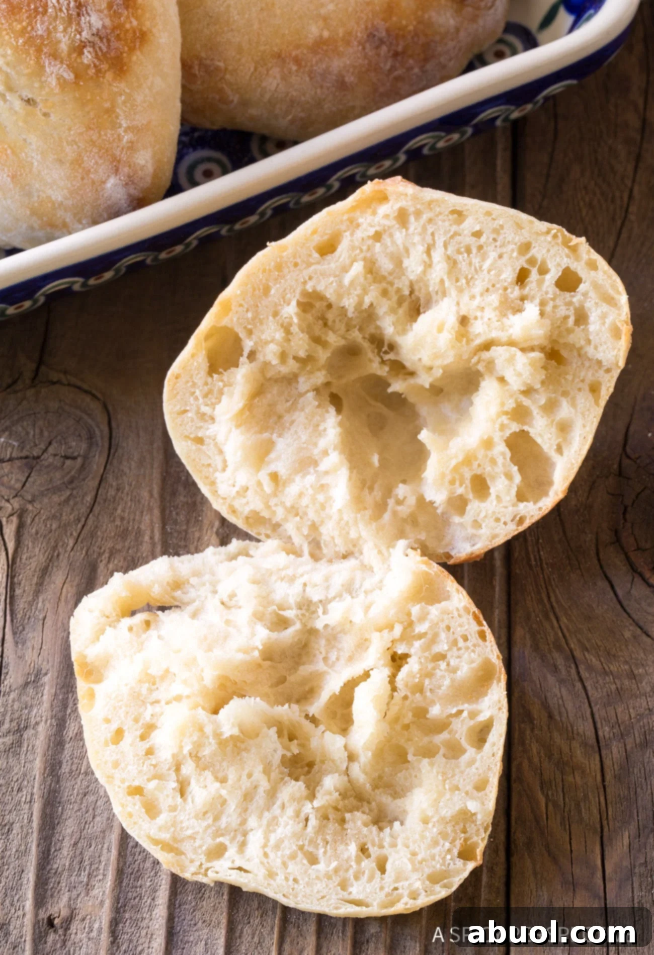 Fluffy Croatian Lepinja Bread 8 Croatian Lepinja Bread cut open on wooden board.