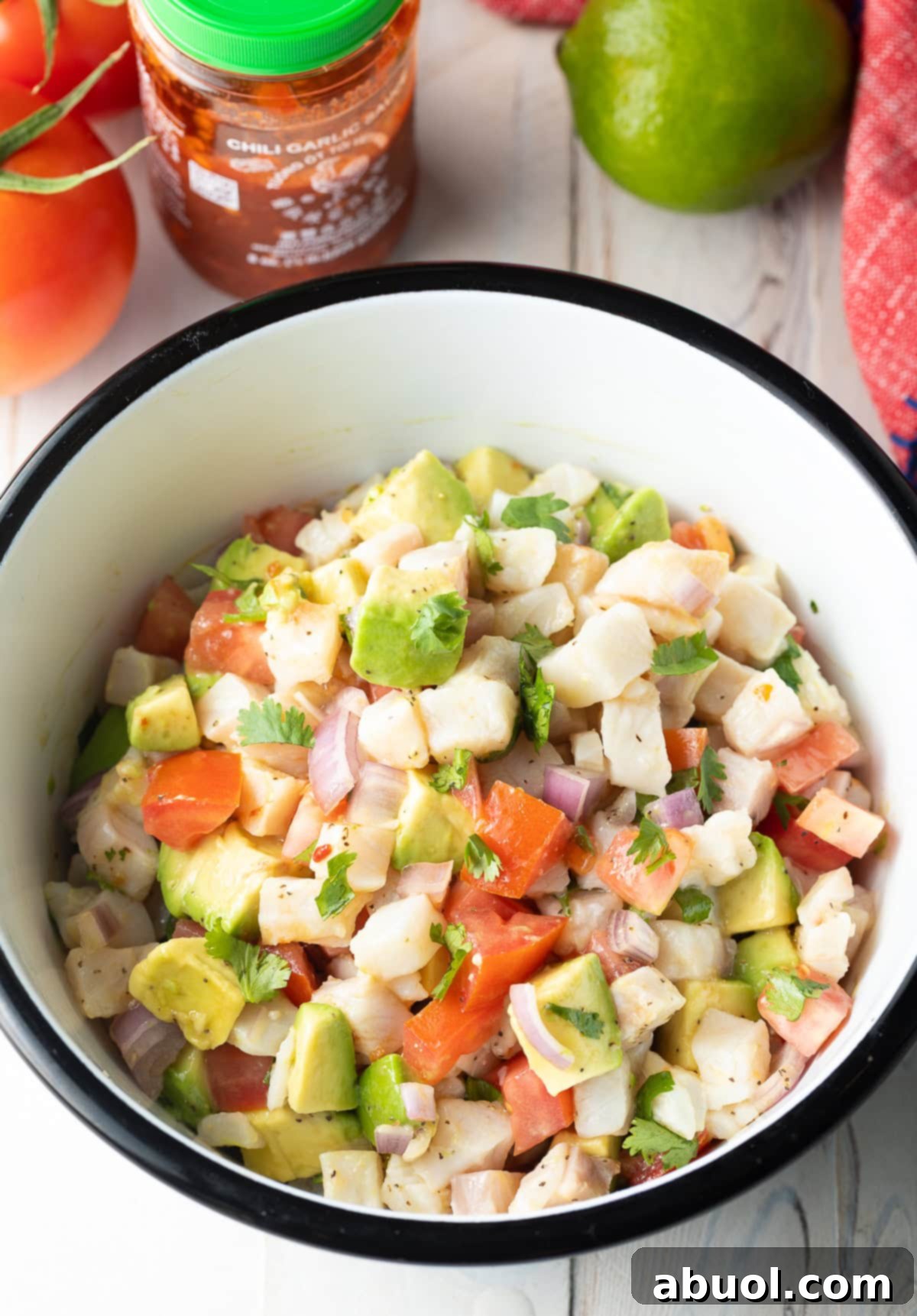 Ceviche de Pescado in bowl with fresh produce - mix together