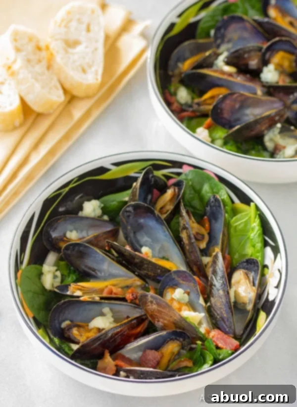 Steaming pot of Mussels with Blue Cheese and Bacon, served with crusty bread