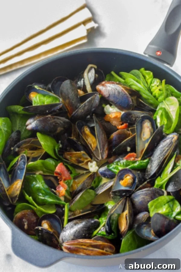 Close-up of freshly cooked Mussels with Blue Cheese and Bacon in a broth