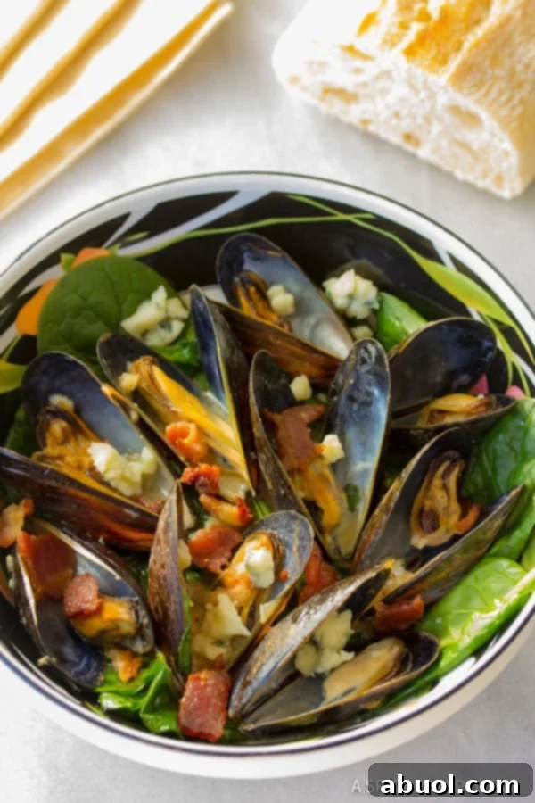 Ingredients for Mussels with Blue Cheese and Bacon laid out on a cutting board