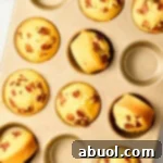 Corn Muffins Recipe - warm cornbread muffins in pan with bacon and maple syrup