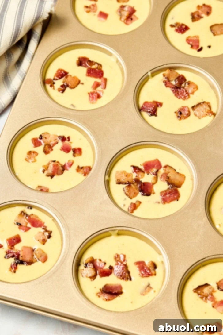 Heavenly Bacon Corn Muffins 8 Corn muffin batter carefully poured into a greased muffin pan, ready for baking.