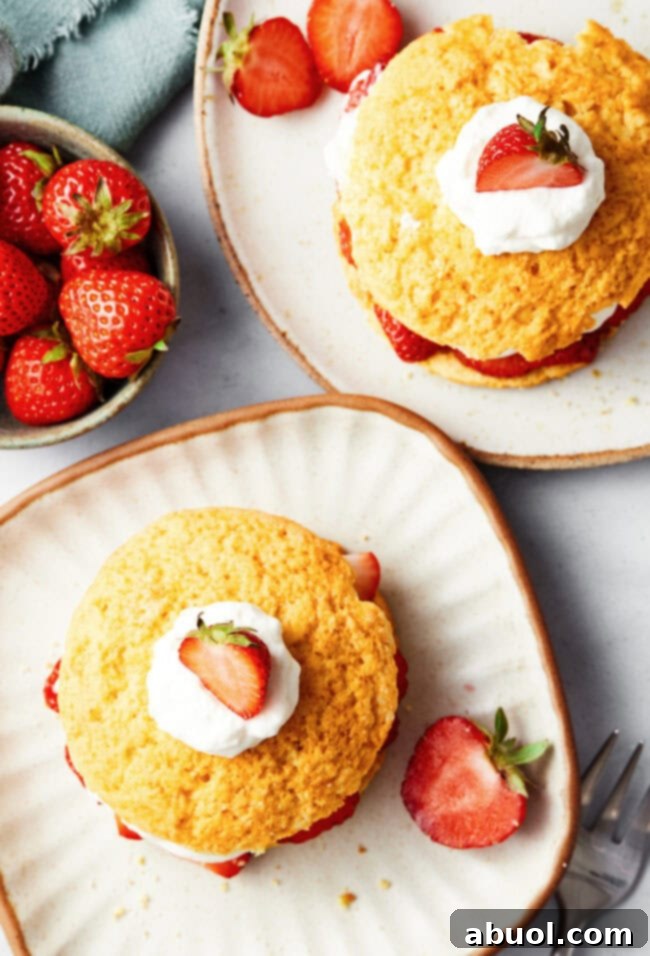 An overhead shot showcasing several baked cornmeal shortcake biscuits, golden brown and perfectly risen, cooling on a wire rack.