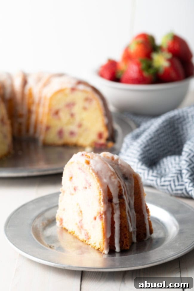 Strawberry lemon bundt cake slice on a silver plate.