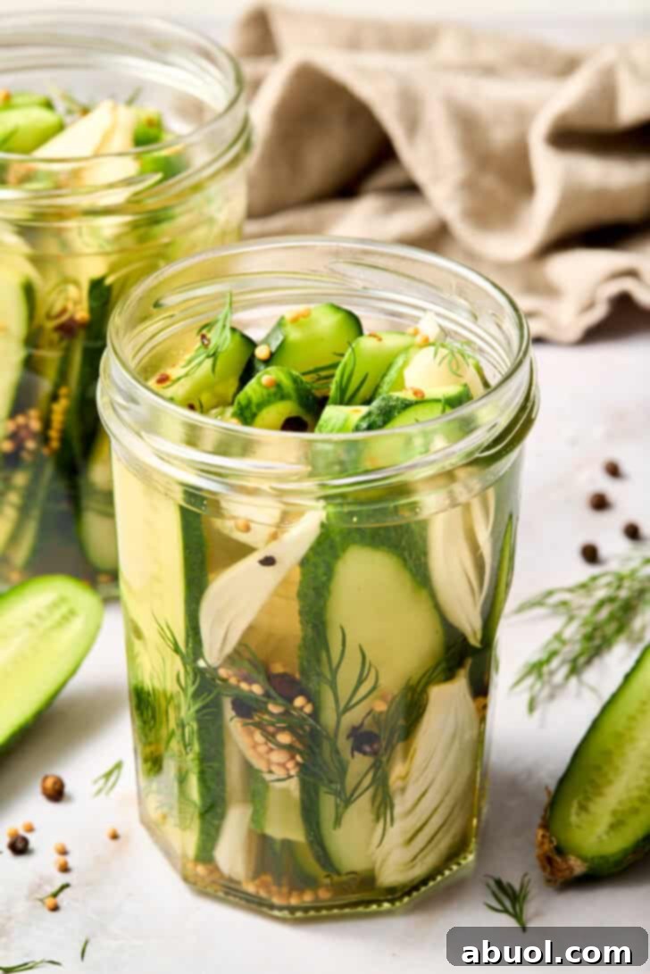 Best Homemade Refrigerator Dill Pickles - front view of a jar packed with fresh dill and sliced cucumbers