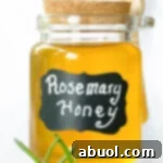 A small jar of finished herb-infused honey.